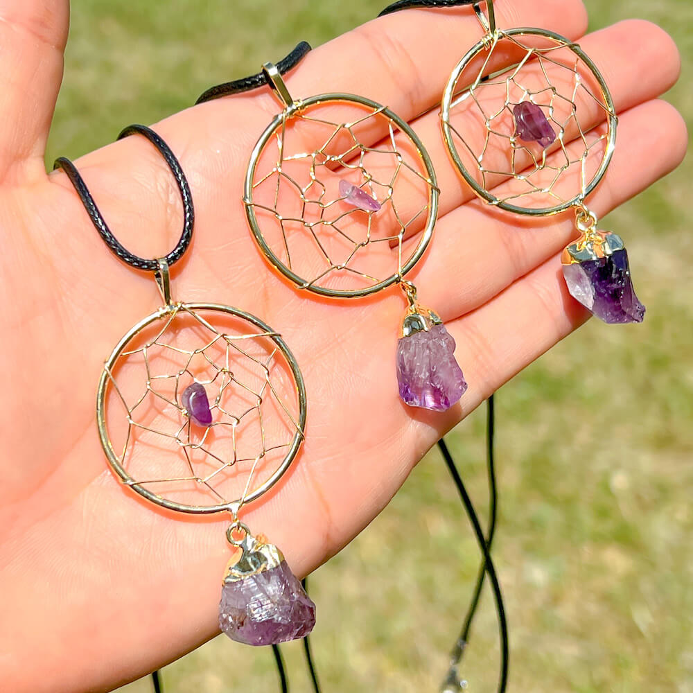 Gorgeous gold plated Amethyst Dreamcatcher gold Necklace adorned with an Amethyst crystal bead and a raw Amethyst crystal hanging from the bottom. Shop at Magic Crystals for Amethyst Jewelry, Healing Crystals, and Stones. Perfect gift for someone or to wear every day. Boho Jewelry, February Birthstone.