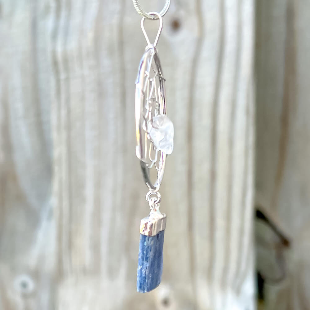 Gorgeous silver plated Blue Kyanite Dreamcatcher Silver Necklace adorned with a quartz crystal bead and a raw Blue Kyanite crystal hanging from the bottom. Shop at Magic Crystals for Blue Kyanite Jewelry, Healing Crystals, and Stones. Perfect gift for someone or to wear every day. Boho Jewelry, Communication stone