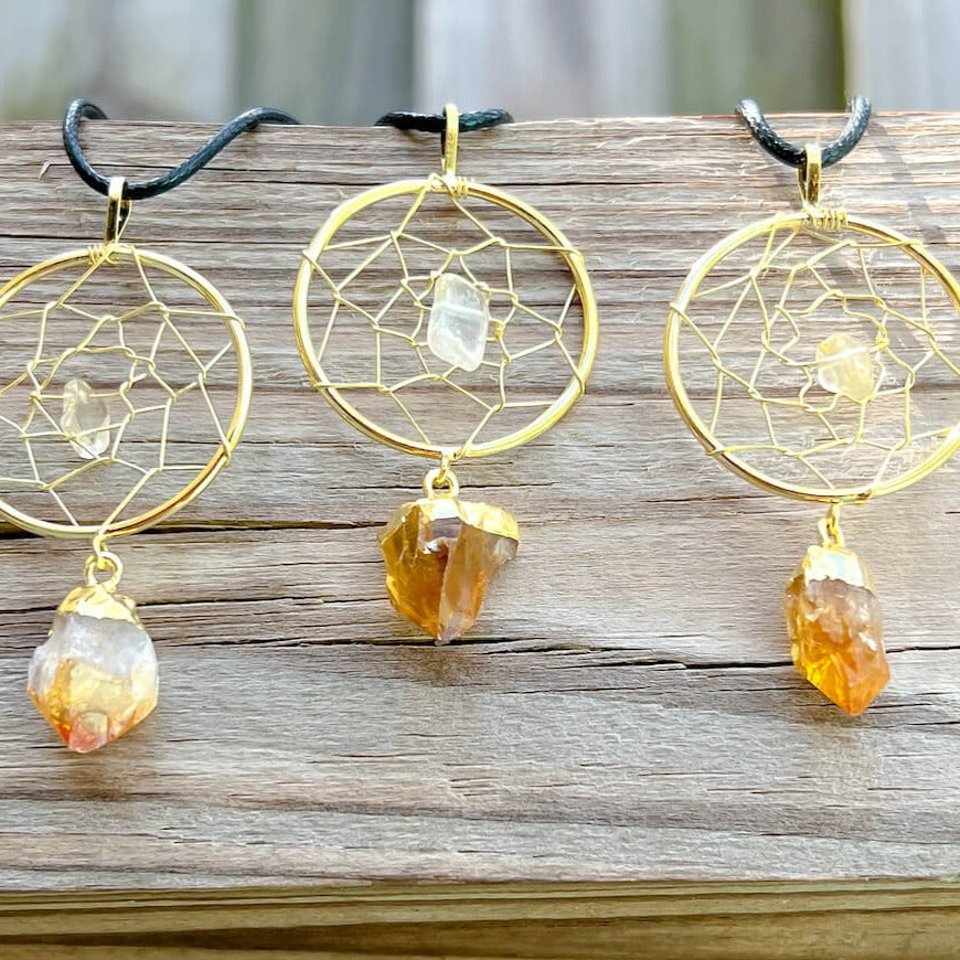 Gorgeous gold plated Citrine Dreamcatcher gold Necklace adorned with a clear quartz crystal bead and a raw Citrine crystal hanging from the bottom. Shop at Magic Crystals for Citrine Jewelry, Healing Crystals, and Stones. Perfect gift for someone or to wear every day. Boho Jewelry, February Birthstone.