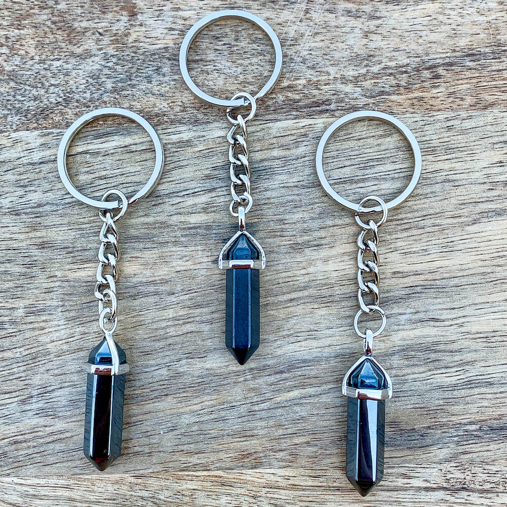Hematite KEYCHAIN. Shop at Magic Crystals for Crystal Keychain, Pet Collar Charm, Bag Accessory, natural stone, crystal on the go, keychain charm, gift for her and him. Hematite is a great SPIRITUALITY. FREE SHIPPING available. Hematite Crystal Key Chain, Crystal Keyring, Hematite Crystal Key Holder. Gray stone keys.
