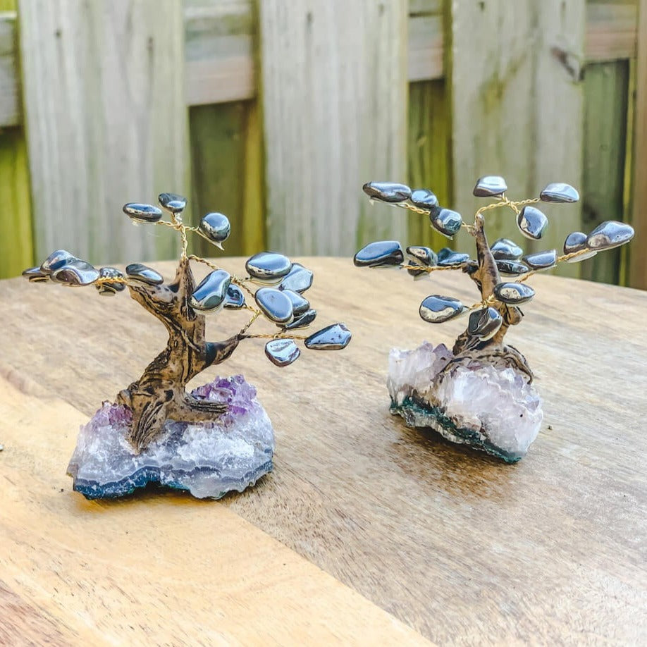 Looking for crystal home decor? Shop at Magiccrystals.com for Mini Gray Hematite Bonsai Tree on Amethyst Cluster. Magic Crystals has a variety of HOME DECOR made of crystals and gemstones. Hematite is known as the stone of grounding. Gemstone tree. Birthstone tree sculpture. Amethyst geode gift. FREE SHIPPING AVAILABLE