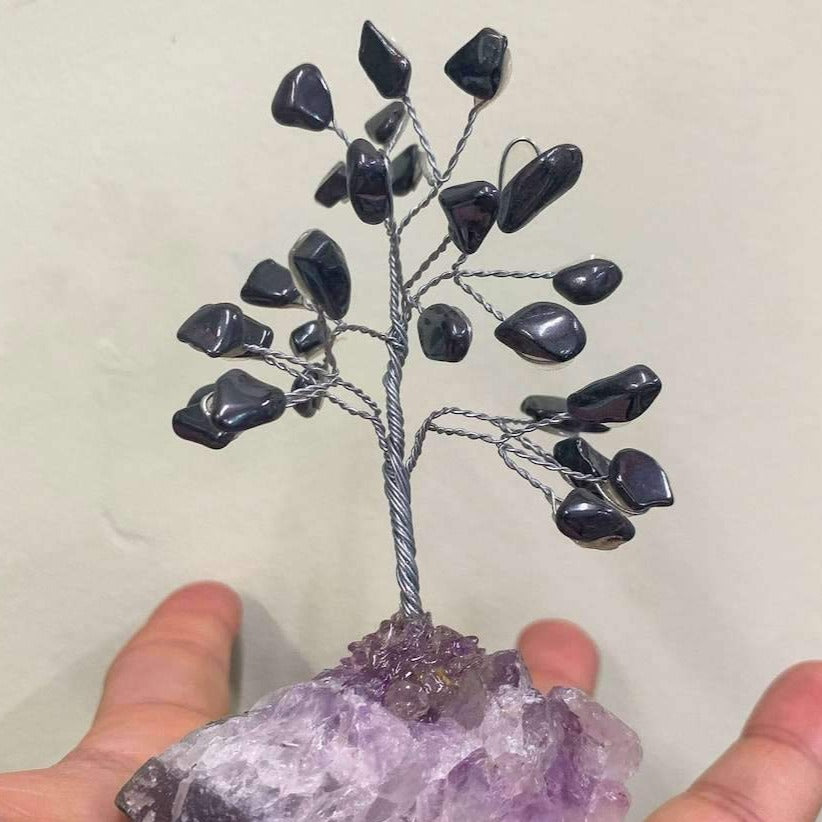 Looking for crystal home decor? Shop at Magiccrystals.com for Mini Gray Hematite Bonsai Tree on Amethyst Cluster. Magic Crystals has a variety of HOME DECOR made of crystals and gemstones. Hematite is known as the stone of grounding. Gemstone tree. Birthstone silver plated wire tree sculpture. Amethyst geode gift.