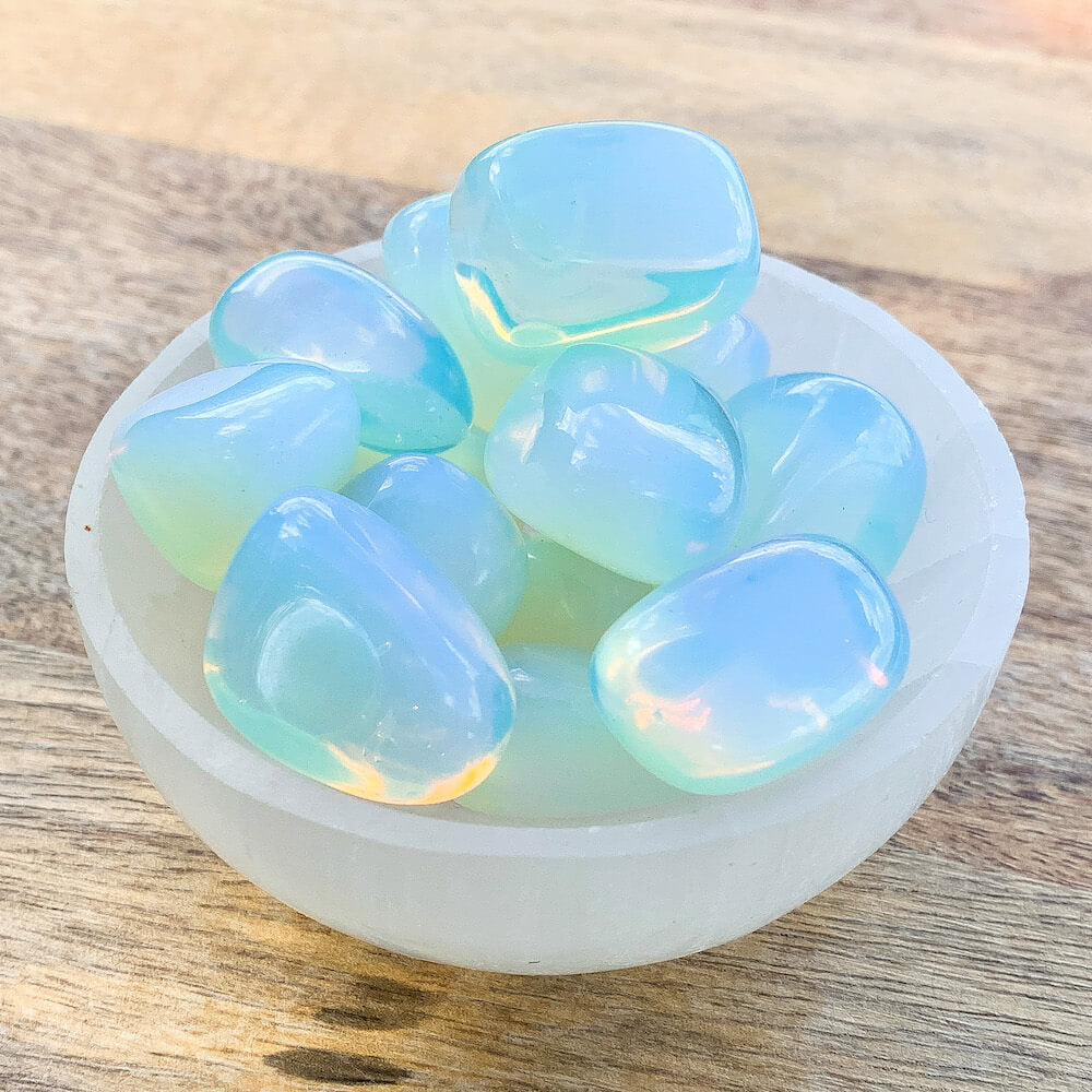 Buy Opalite Tumbled Stones | Opalite Polished Gemstones | Bulk Crystals at Magic Crystals. Opalite Jewelry with FREE SHIPPING available. Opalite is a stone of emotional balance. Opalite improves your sense of self-worth, assists in making smooth transitions & also useful in helping success in business.
