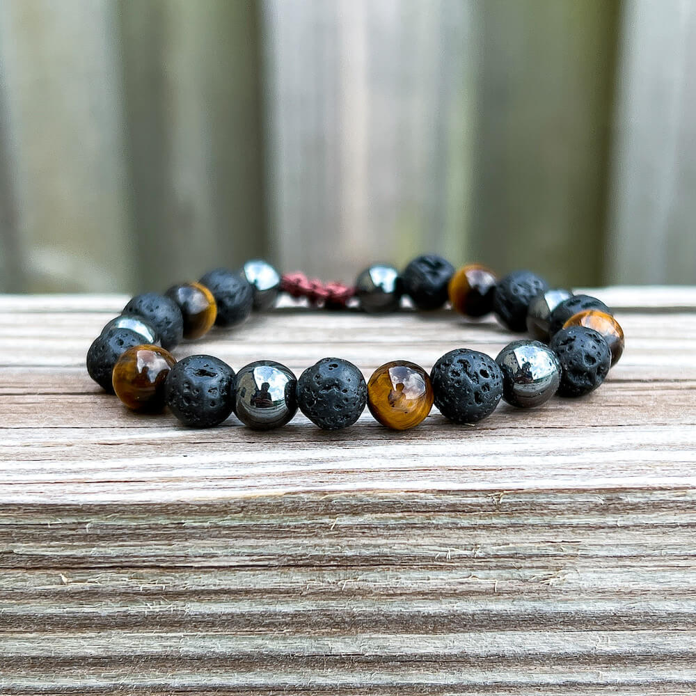 Looking for a protection bracelet? Shop at Magic Crystals for Yellow Tiger Eye, Hematite, and Lava Stone Bracelet. Bracelet made of natural gemstones and Lava stones for Oils Diffuser. Unisex jewelry adjustable bracelet. Color: Black and metallic, gray for Chakra: Third Eye, Solar Plexus, Sacral, Root. FREE SHIPPING