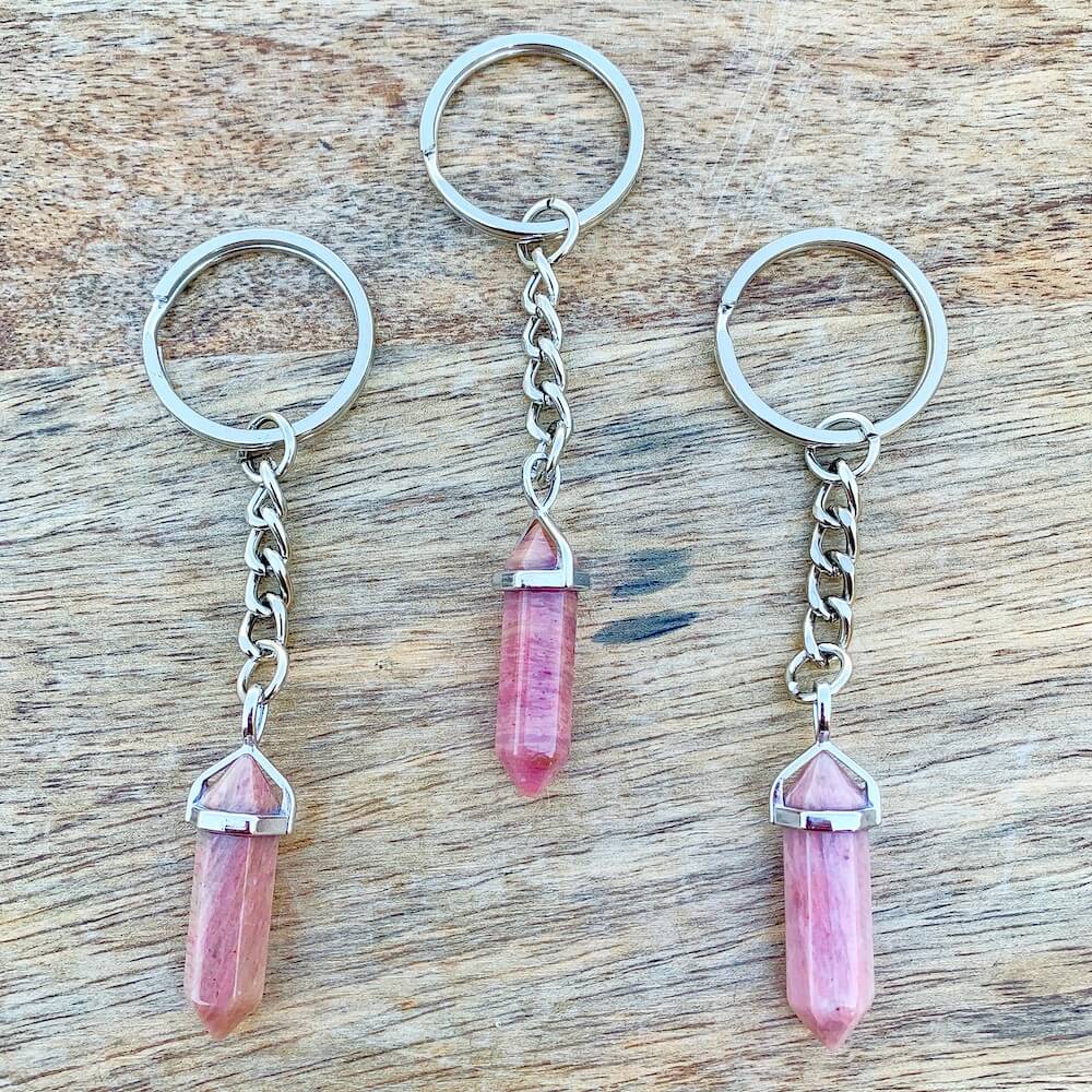 Rhodochrosite KEYCHAIN. Shop at Magic Crystals for Crystal Keychain, Pet Collar Charm, Bag Accessory, natural stone, crystal on the go, keychain charm, gift for her and him. Rhodochrosite is a great SPIRITUALITY. FREE SHIPPING available. Rhodochrosite Crystal Key Chain, Crystal Keyring, Rhodochrosite Crystal Key Holder