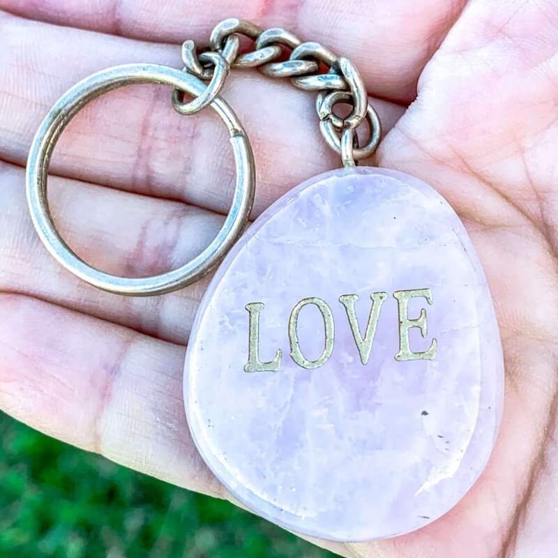 Rose Quartz Palm Stone Keychain. Rose Quartz keychain. Shop at Magic Crystals for Crystal Keychain, Pet Collar Charm, Bag Accessory, natural stone, crystal on the go, keychain charm, gift for her and him. Rose Quartz is a great LOVE. Rose Quartz Natural Stone Keychain, Crystal Keychain,Rose Quartz Crystal Key Holder. Pink gemstone.