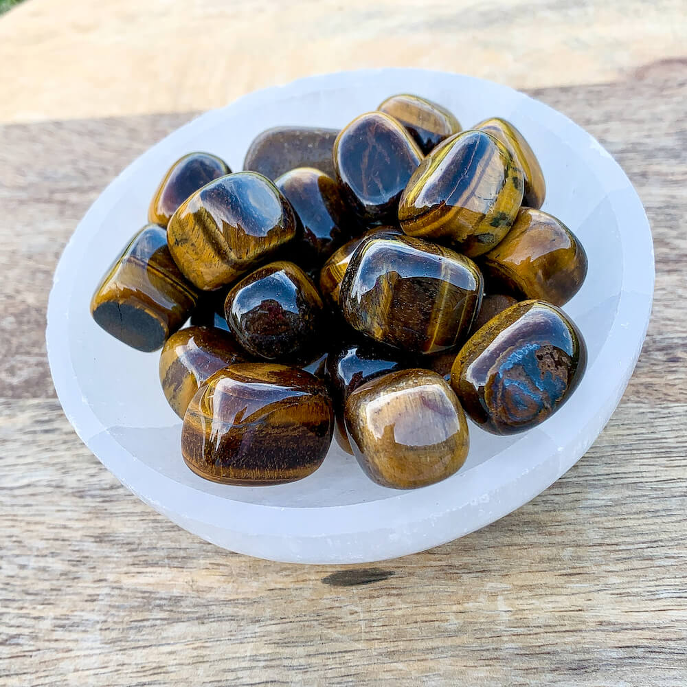 Looking for Yellow Tiger Eye Tumbled Stone? Shop at Magic Crystals for Tiger Eye TUMBLED from Africa. Tumbled Tiger Eye also known as a Third Eye, Sacral Chakra gemstone is wonderful for balance, energy healing, and reiki. Tigers Eye Jewelry, Stones, bracelets, necklaces, and more with FREE SHIPPING available.