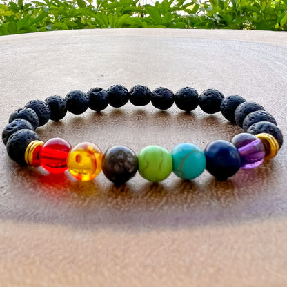 Essential oil diffusing bracelet! Crafted from highly absorbent lava stone, this 7 Chakra Lava Stone Bracelet allows you to enjoy the soothing benefits of aromatherapy at all times. Unisex bracelet, magiccrystals. 7 Chakra and Black Lava Stone - Lava Stone Bracelet
