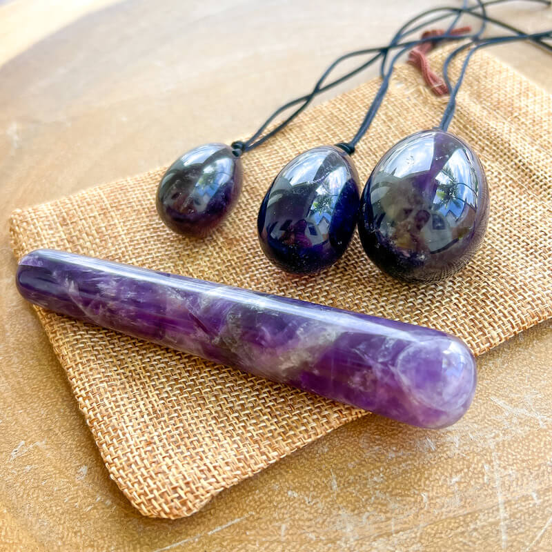 Amethyst-Yoni Eggs Set and Massage Wand. These Natural Stone Yoni Egg Set and Massage Wand from Magic Crystals help you build an intimate connection with your body. Polished yoni egg crystals and wand are drilled available in Black Onyx,  Opalite, Unakite, Nephrite Jade, tiger Eye, Clear Quartz, Red jasper, Aventurine, Amethyst, Rose Quartz
