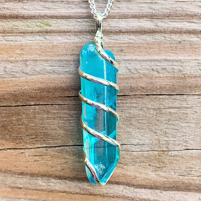 Looking for Point Natural Aura Quartz Jewelry? Magic Crystals carries a variety of Aura Quartz Spiral Wrapped Necklace. Quartz Crystal Point necklace. Wrap Necklace for Men Women. Rose, Angel, Purple, Blue Aqua, Sunshine, Ruby, Rainbow, Sunshine, Green Apple, Deep Blue, Tangerine, Deep Rose Aura Quartz