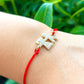    Boy-and-Girl-Red-String-Bracelet. Shop at Magic Crystals for Protection. The Red String Bracelet has been worn throughout history in many cultures as a symbol of protection, faith, and good luck and acts as a shield from negativity and actually has many positive effects. In quite a few cultures a red string bracelet is believed to have magical powers.