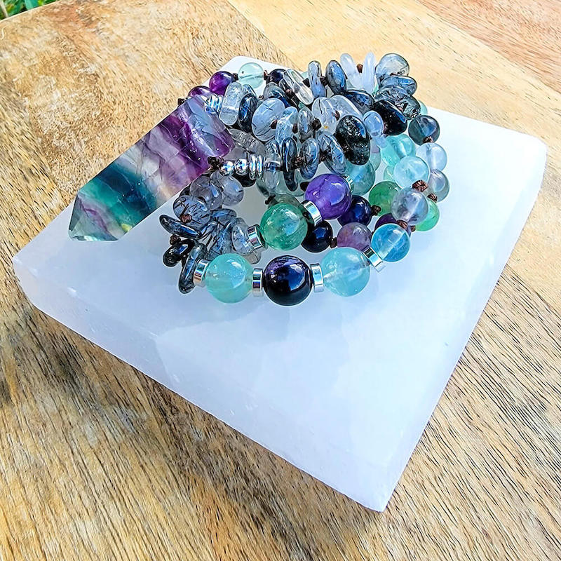 Looking for Fluorite Crystal Mala - Handcrafted for Chakra Energy? Shop at Magic Crystals. Wearing, carrying, or meditating with this Flurotie crystal mala can open the mind and heart to higher guidance. Features a combination of Tourmalinated Quartz and Fluorite beads with a double point as a center piece. SHIPS FREE