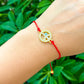 Golden-Piece-Eye-Red-String-Bracelet. Shop at Magic Crystals for Protection. The Red String Bracelet has been worn throughout history in many cultures as a symbol of protection, faith, and good luck and acts as a shield from negativity and actually has many positive effects. In quite a few cultures a red string bracelet is believed to have magical powers.