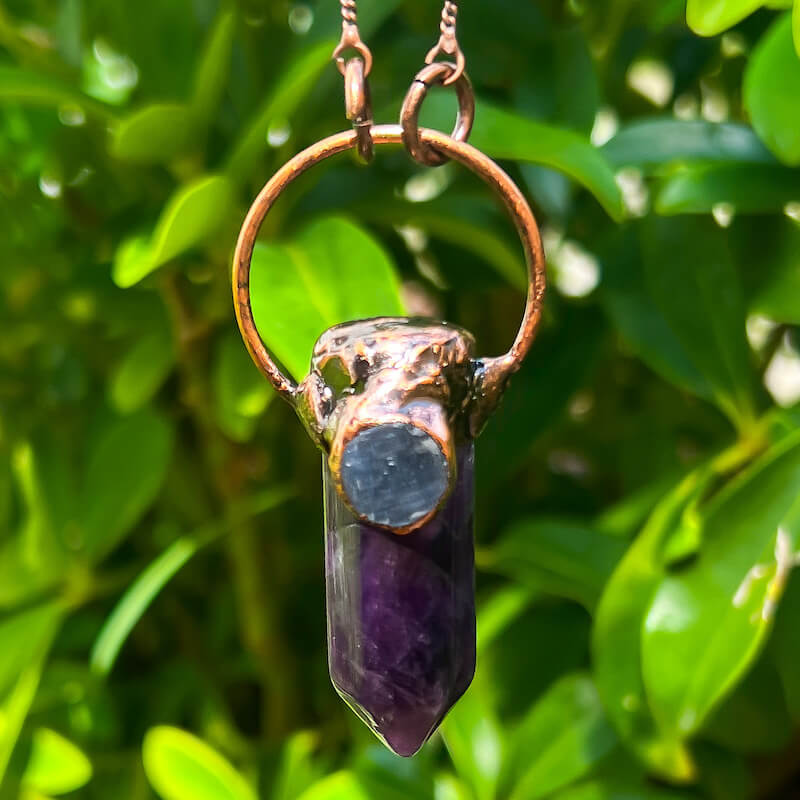 Handmade-Amethyst-and-Kyanite-bronze-necklace. Natural handcrafted bronze necklaces, perfect accessory to spice up your wardrobe with a touch of bohemian flair. Our bronze necklace collection includes hand carved pendants made of natural Amethyst, Clear Quartz, Labradorite, Rose Quartz, Blue Kyanite and more! A true timeless fashion statement.