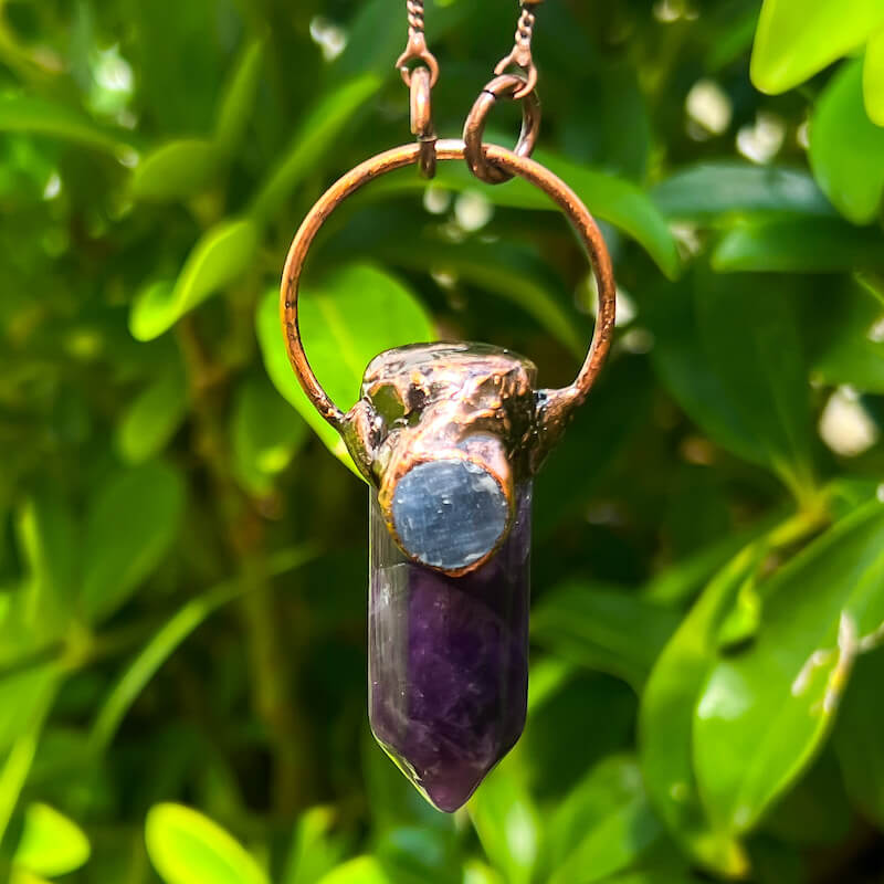 Handmade-Amethyst-and-Kyanite-bronze-necklace. Natural handcrafted bronze necklaces, perfect accessory to spice up your wardrobe with a touch of bohemian flair. Our bronze necklace collection includes hand carved pendants made of natural Amethyst, Clear Quartz, Labradorite, Rose Quartz, Blue Kyanite and more! A true timeless fashion statement.