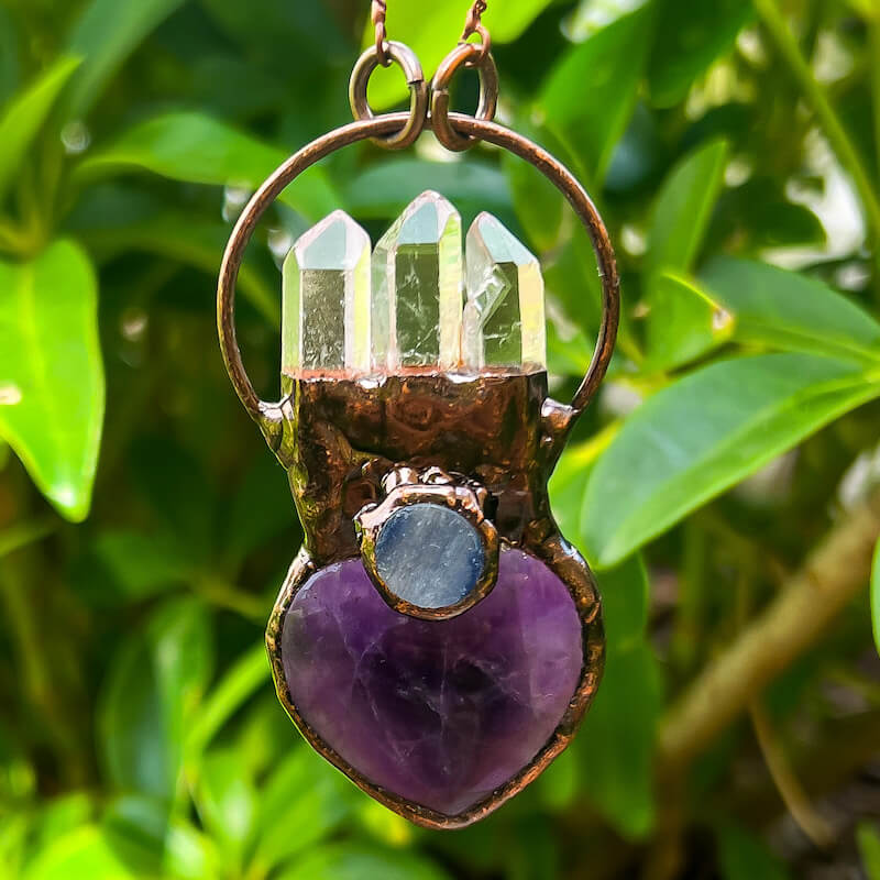 Handmade-Amethyst-clear-quartz-kyanite-bronze-necklace. Natural handcrafted bronze necklaces, perfect accessory to spice up your wardrobe with a touch of bohemian flair. Our bronze necklace collection includes hand carved pendants made of natural Amethyst, Clear Quartz, Labradorite, Rose Quartz, Blue Kyanite and more! A true timeless fashion statement.
