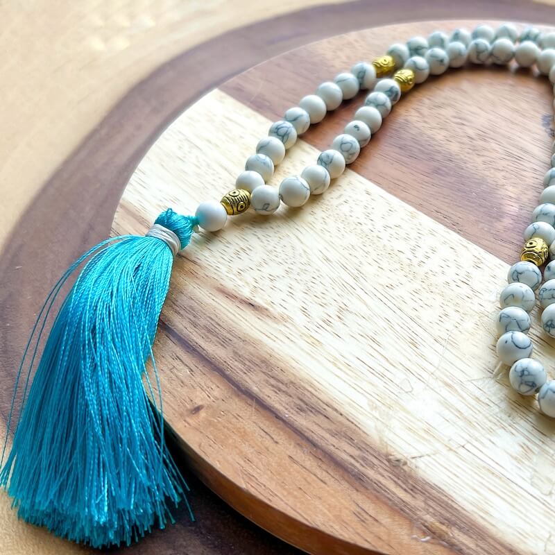 Shop beautiful hand crafted Natural Gemstone Mala Necklace - Prayer Beads at Magic Crystals. High quality Prayer Beads, Including Lapis Lazuli, Larvikite, Snowflake Obsidian, Howlite, Black Agate, Picture Jasper, Red Jasper, and Amethyst. Handcrafted with 108 beads, can be worn as a necklace or bracelet.