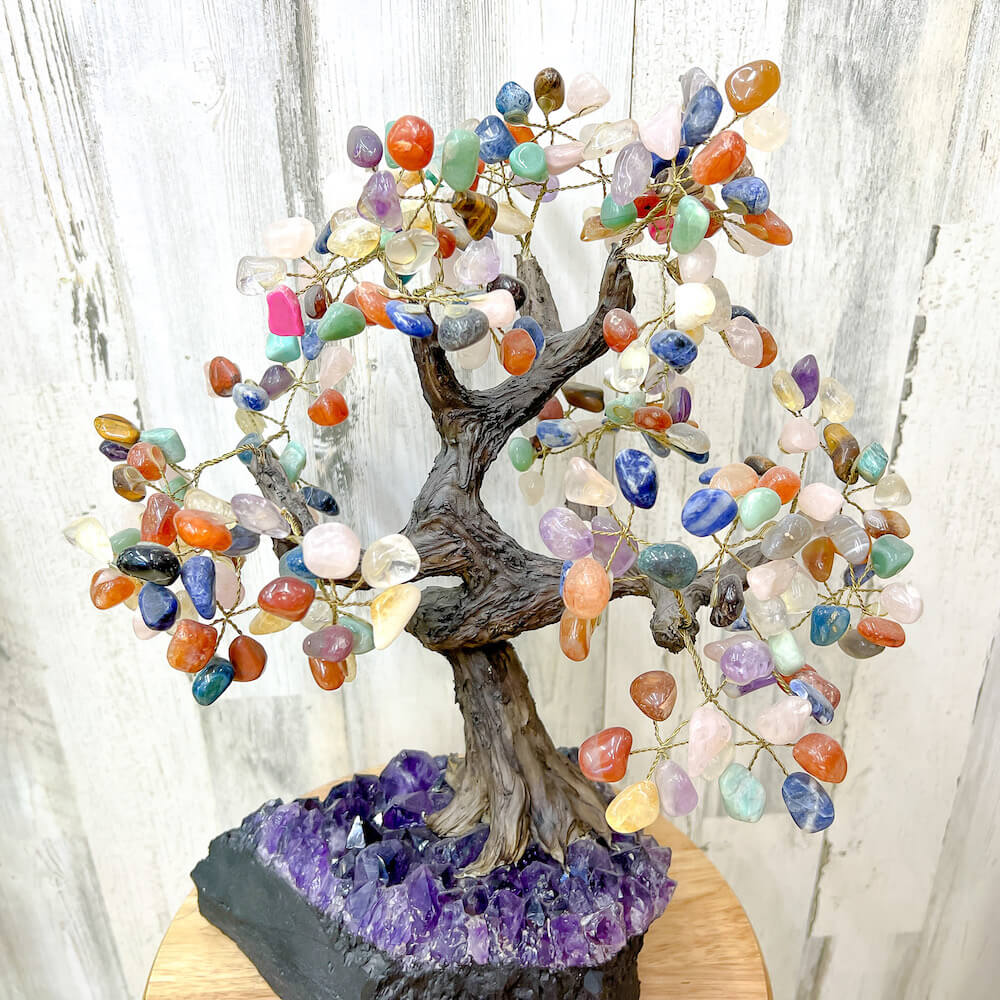 Looking for a large gemstone tree? Shop at Magic Crystals for a 17" - LARGE Multi Gemstone Tree on Amethyst Base with Authentic Crystals. Handmade Gemstone Tree w/Amethyst base. Druzy Amethyst Base. Materials Carnelian, Sodalite, Red Agate, Citrine, Green aventurine, Amethyst, Clear quartz, Rose Quartz and more.