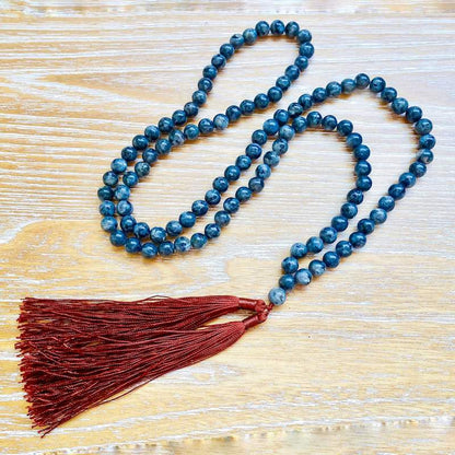Shop beautiful hand crafted Natural Gemstone Mala Necklace - Prayer Beads at Magic Crystals. High quality Prayer Beads, Including Lapis Lazuli, Larvikite, Snowflake Obsidian, Howlite, Black Agate, Picture Jasper, Red Jasper, and Amethyst. Handcrafted with 108 beads, can be worn as a necklace or bracelet.