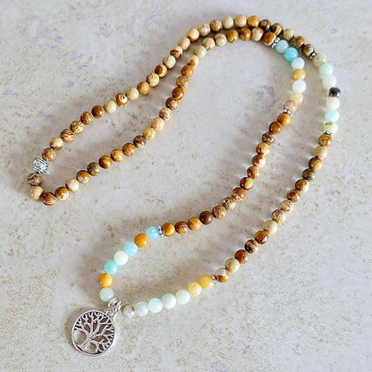 Shop beautiful hand crafted Natural Gemstone Mala Necklace - Prayer Beads at Magic Crystals. High quality Prayer Beads, Including Lapis Lazuli, Larvikite, Snowflake Obsidian, Howlite, Black Agate, Picture Jasper, Red Jasper, and Amethyst. Handcrafted with 108 beads, can be worn as a necklace or bracelet.