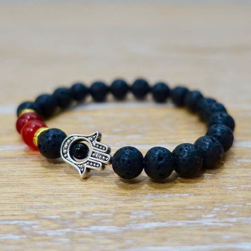 Looking for Lava Jewelry? Shop at Magic Crystals for Lava Stone golden Hamsa Bracelet. Lava Stone is the igneous volcanic rock that is basically molten lava that has solidified under intense pressure and heat. It is a stone of strength, fire, passion and courage. Black gemstone bracelet. FREE SHIPPING available.