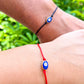 Blue-Evil-Eye-Red-String-Bracelet. Shop at Magic Crystals for Protection. The Red String Bracelet has been worn throughout history in many cultures as a symbol of protection, faith, and good luck and acts as a shield from negativity and actually has many positive effects. In quite a few cultures a red string bracelet is believed to have magical powers.