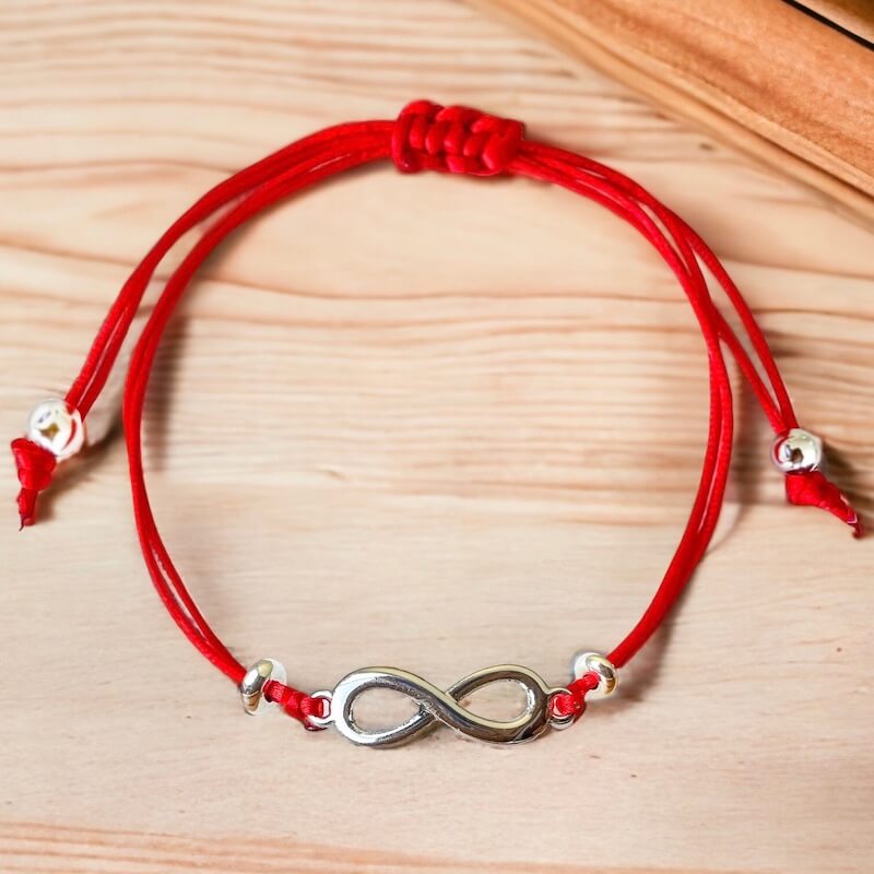 Infinity-Red-String-Bracelet. Shop at Magic Crystals for Protection. The Red String Bracelet has been worn throughout history in many cultures as a symbol of protection, faith, and good luck and acts as a shield from negativity and actually has many positive effects. In quite a few cultures a red string bracelet is believed to have magical powers.