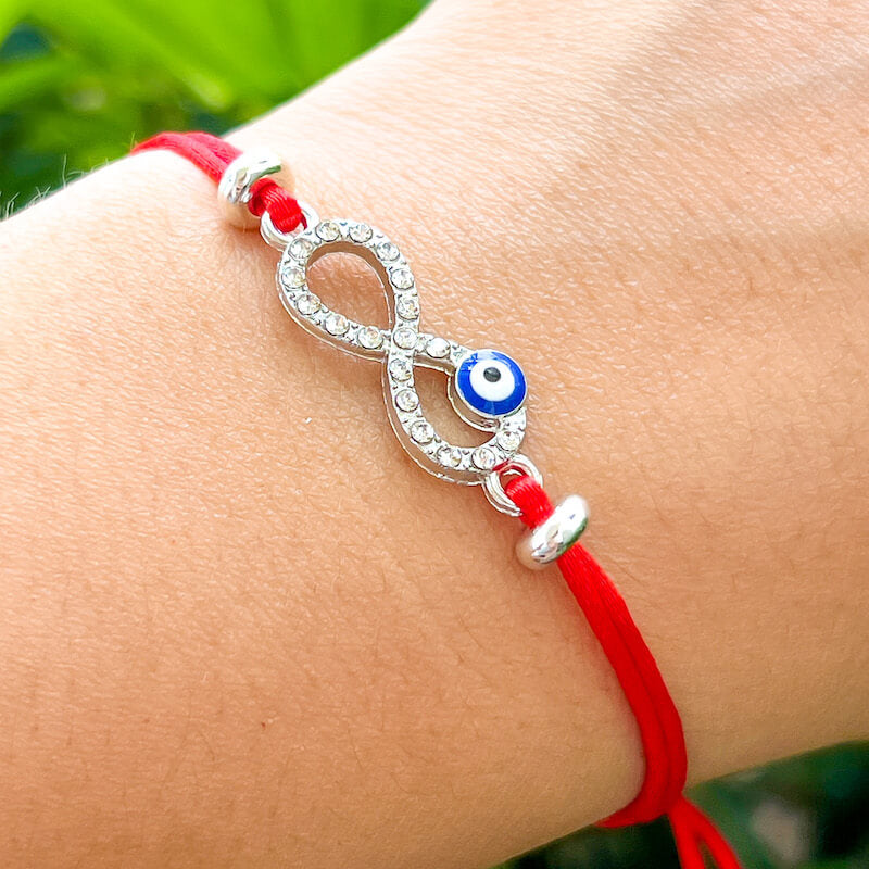 Infinity-Sign-Golden-Blue-Eye-Red-String-Bracelet. Shop at Magic Crystals for Protection. The Red String Bracelet has been worn throughout history in many cultures as a symbol of protection, faith, and good luck and acts as a shield from negativity and actually has many positive effects. In quite a few cultures a red string bracelet is believed to have magical powers.