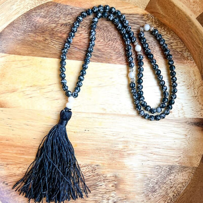Shop beautiful hand crafted Natural Gemstone Mala Necklace - Prayer Beads at Magic Crystals. High quality Prayer Beads, Including Lapis Lazuli, Larvikite, Snowflake Obsidian, Howlite, Black Agate, Picture Jasper, Red Jasper, and Amethyst. Handcrafted with 108 beads, can be worn as a necklace or bracelet.
