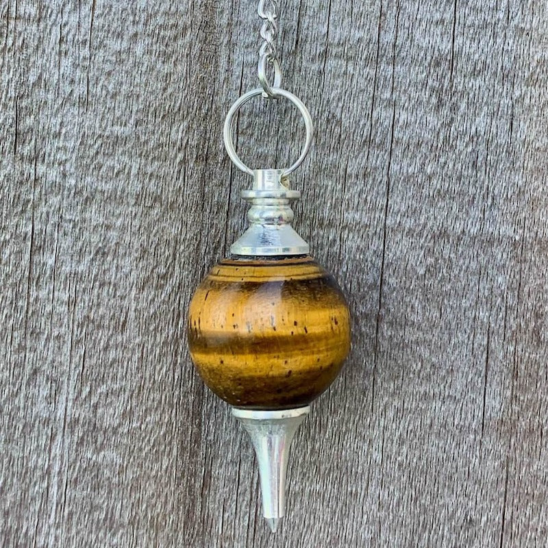 Tiger-Eye Sphere Pendulum. Find Tiger-Eye   Sphere Pendulum - Tiger-Eye Pendant crystal pendulum dowsing when you shop at Magic Crystals. Yellow and Brown Pendulum.