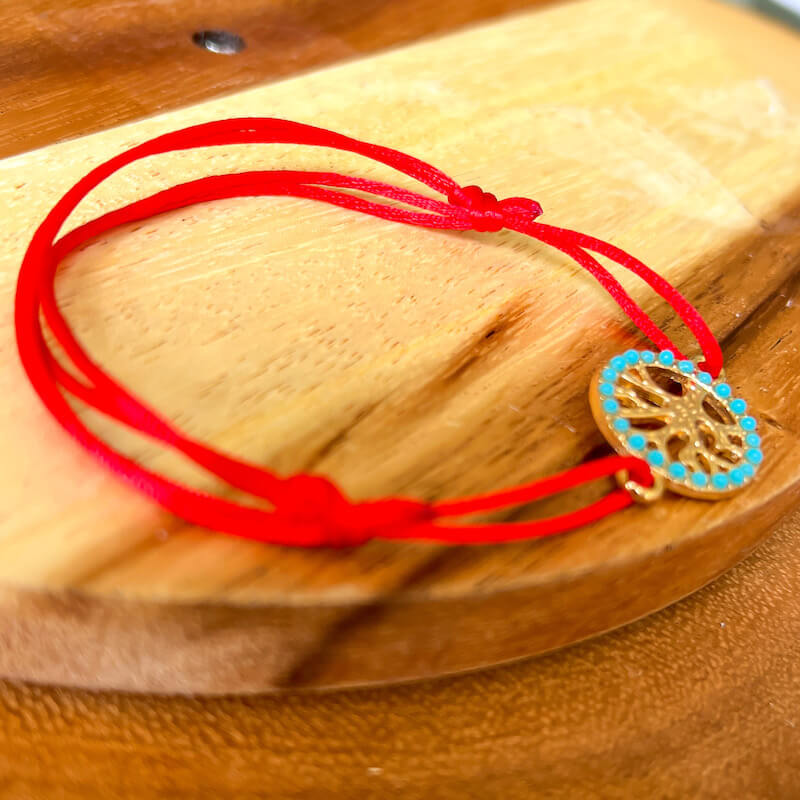 Tree-of-Life-Red-String-Bracelet. Shop at Magic Crystals for Protection. The Red String Bracelet has been worn throughout history in many cultures as a symbol of protection, faith, and good luck and acts as a shield from negativity and actually has many positive effects. In quite a few cultures a red string bracelet is believed to have magical powers.