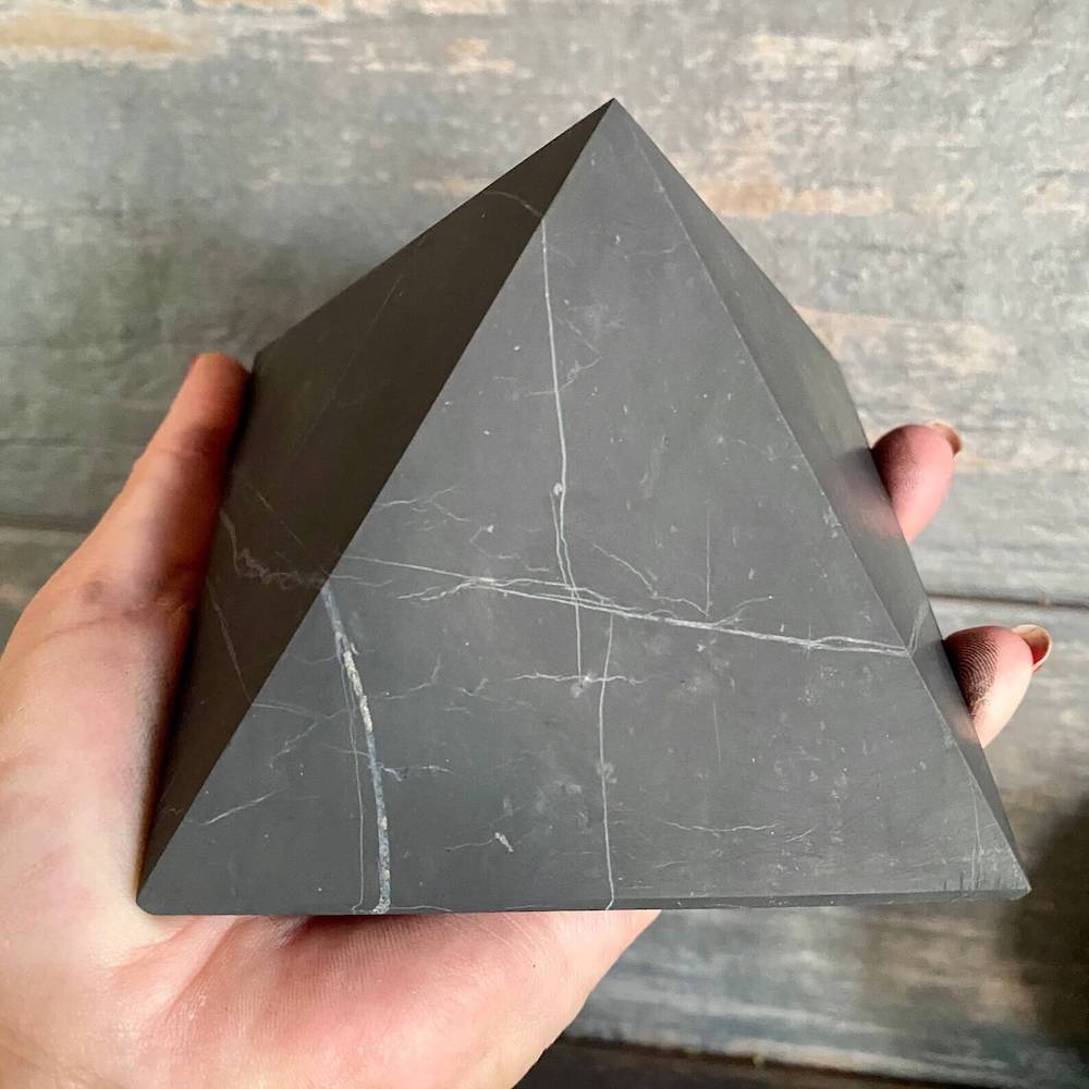 Shungite Pyramid helps for EMF Protection. Pyramid is Black Polished Authentic from Karelian for Anti-Radiation. Shungite Stone Figure from Karelia Energy Pyramid from Russia. Chakra Healing Stone, Block EMF's WIFI Radiation 5G at magiccrystals.com . Shop online with FREE SHIPPING AVAILABLE.