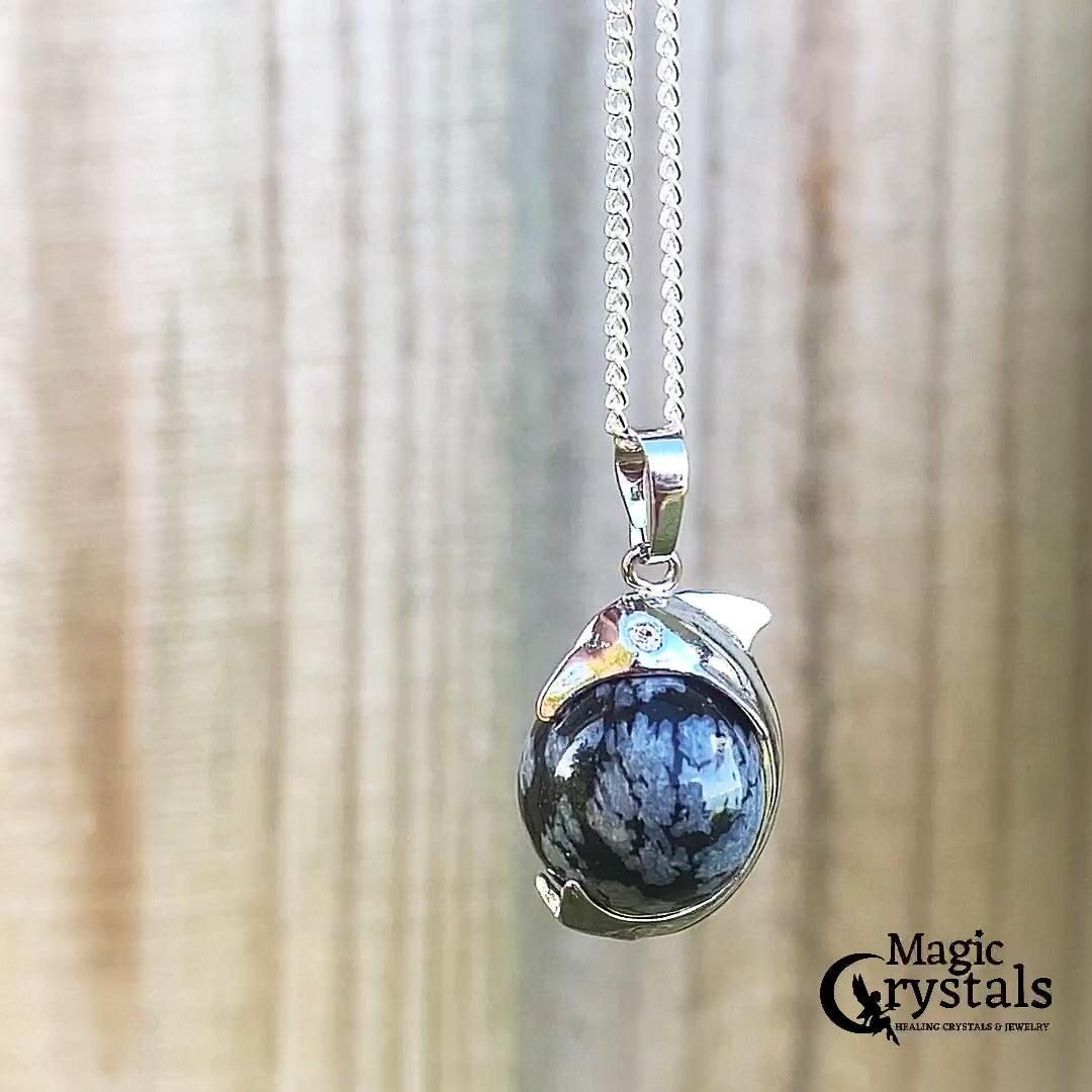  Snowflake-Obsidian-Sphere-Dolphin-Pendant-Necklace. Dolphin Necklace - Elegant Ocean-Themed Jewelry for Women Dolphin Charm Necklace at Magic Crystals. Boho Style Jewelry with Natural Gemstones. Stone Carved Dolphin Necklace Pendant, Beach Surf Ocean Boho Gemstone Whale Fairtrade Gift. These beautiful stone necklaces are all hand carved.