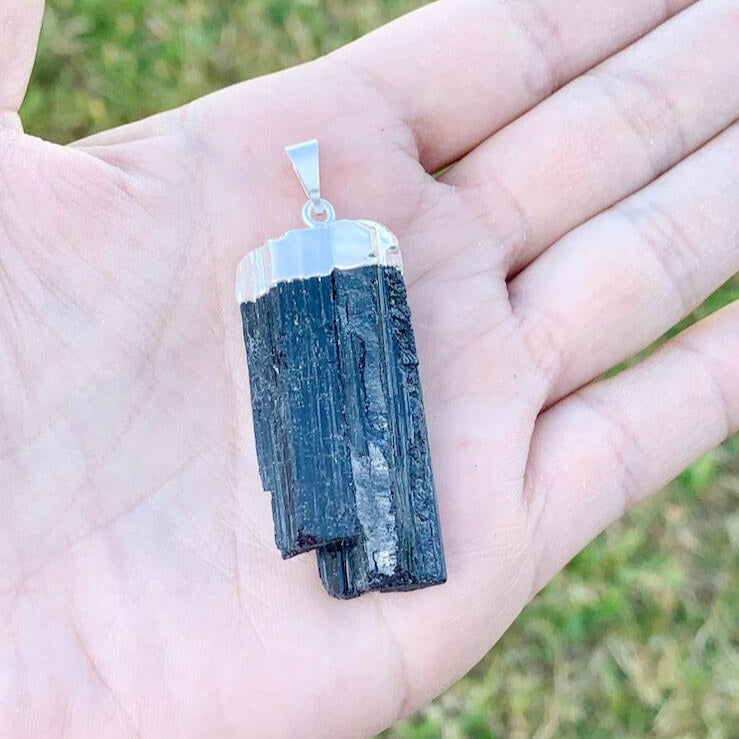 Check out our Raw Black Tourmaline Crystal Pendant Silver Necklace. The Best Quality Handmade Healing Crystal Gemstones for Protection. This is a Great Stone to Keep you grounded and Align your Root Chakra. Black Tourmaline Also Aids in the Removal of Negative Energies Within a Person or a Space. Magic Crystal Free Shipping Available.