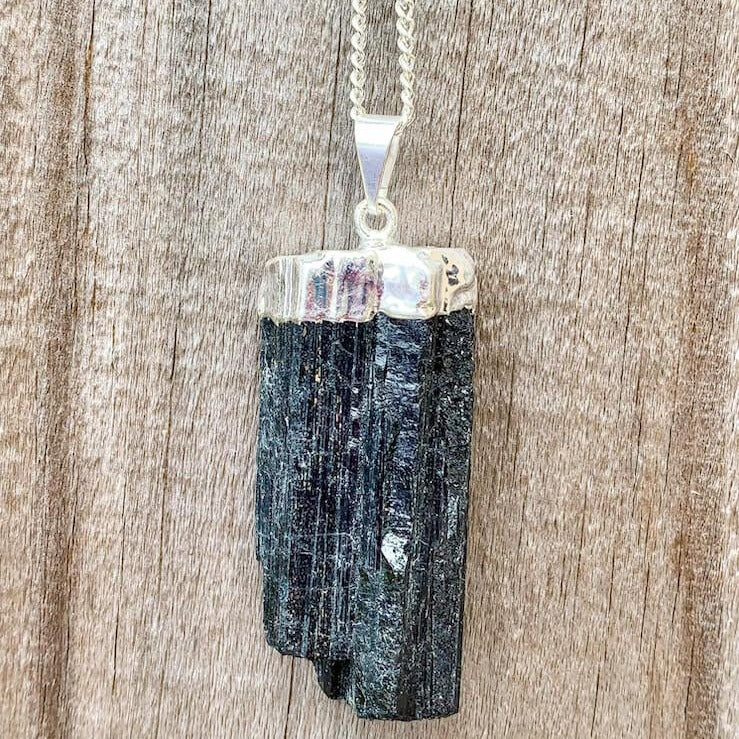 Check out our Raw Black Tourmaline Crystal Pendant Silver Necklace. The Best Quality Handmade Healing Crystal Gemstones for Protection. This is a Great Stone to Keep you grounded and Align your Root Chakra. Black Tourmaline Also Aids in the Removal of Negative Energies Within a Person or a Space. Magic Crystal Free Shipping Available.