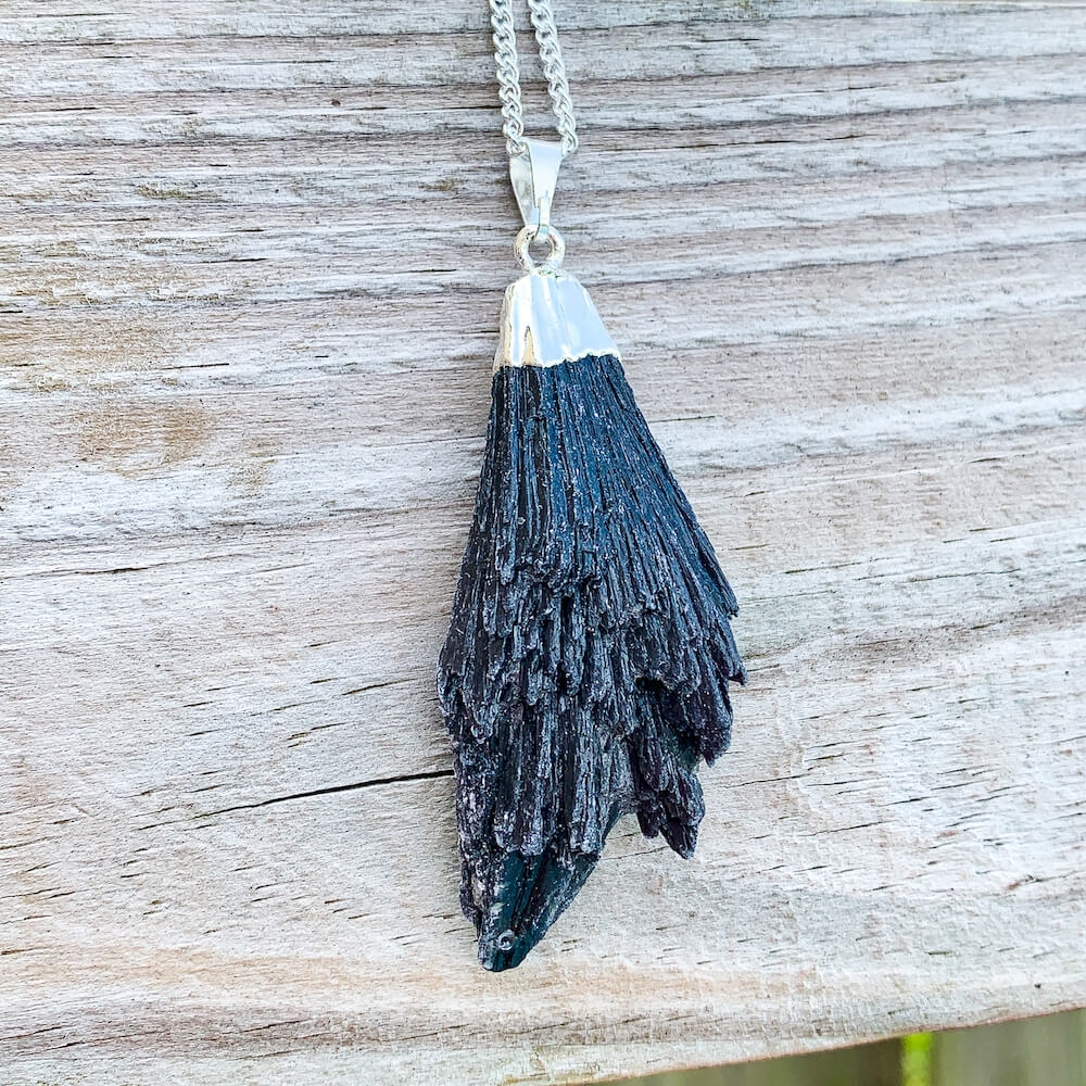 Looking for Black Kyanite Pendant with plated chain? Shop at Magic Crystals for Black Kyanite Fan Necklace. Free shipping available. Black Kyanite Fan, Rough Black Kyanite focus on Protection and Root Chakra. Bohemian Pendant is great for HIM and HER present. Mothers Day fathers day Christmas present.