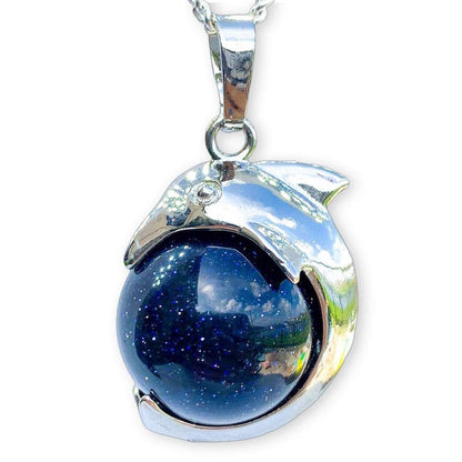       Blue-Goldstone-Sphere-Dolphin-Pendant-Necklace. Dolphin Necklace - Elegant Ocean-Themed Jewelry for Women Dolphin Charm Necklace at Magic Crystals. Boho Style Jewelry with Natural Gemstones. Stone Carved Dolphin Necklace Pendant, Beach Surf Ocean Boho Gemstone Whale Fairtrade Gift. These beautiful stone necklaces are all hand carved.