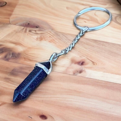 Blue Sandstone keychain. Shop at Magic Crystals for Crystal Keychain, Pet Collar Charm, Bag Accessory, natural stone, crystal on the go, keychain charm, gift for her and him. Blue Sandstone is a great for vitality. Blue Sandstone Natural Stone Keychain, Crystal Keychain, Blue Sandstone Crystal Key Holder. Blue gemstone