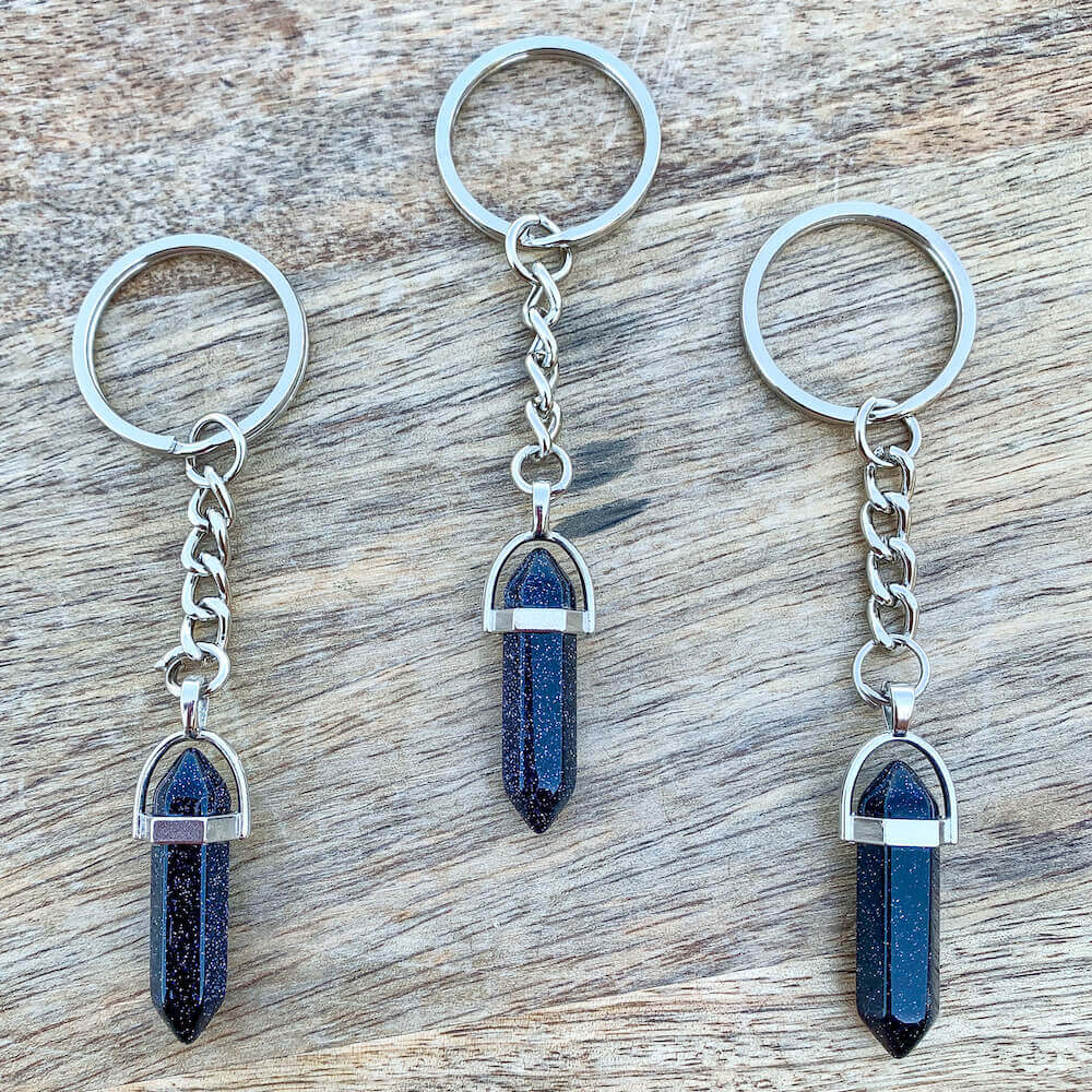 Blue Sandstone keychain. Shop at Magic Crystals for Crystal Keychain, Pet Collar Charm, Bag Accessory, natural stone, crystal on the go, keychain charm, gift for her and him. Blue Sandstone is a great for vitality. Blue Sandstone Natural Stone Keychain, Crystal Keychain, Blue Sandstone Crystal Key Holder. Blue gemstone
