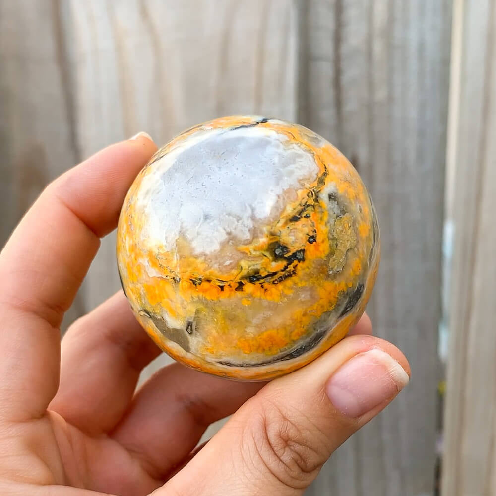 Looking for genuine gemstone spheres? bumble bee jasper? Magic Crystals carries Tumbled Bumblebee Jasper Sphere. This is one summertime Bumble Bee Jasper Sphere.  bumble bee jasper, polished jasper, bumble bee jasper sphere, tumbled stones, tumbled crystals. FREE SHIPPING available.