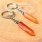 Single Point Carnelian Keychain. Carnelian keychain. Shop at Magic Crystals for Crystal Keychain, Pet Collar Charm, Bag Accessory, natural stone, crystal on the go, keychain charm, gift for her and him. Carnelian is a great for courage. Carnelian Natural Stone Keychain, Crystal Keychain, Carnelian Crystal Key Holder. Yellow gemstone.