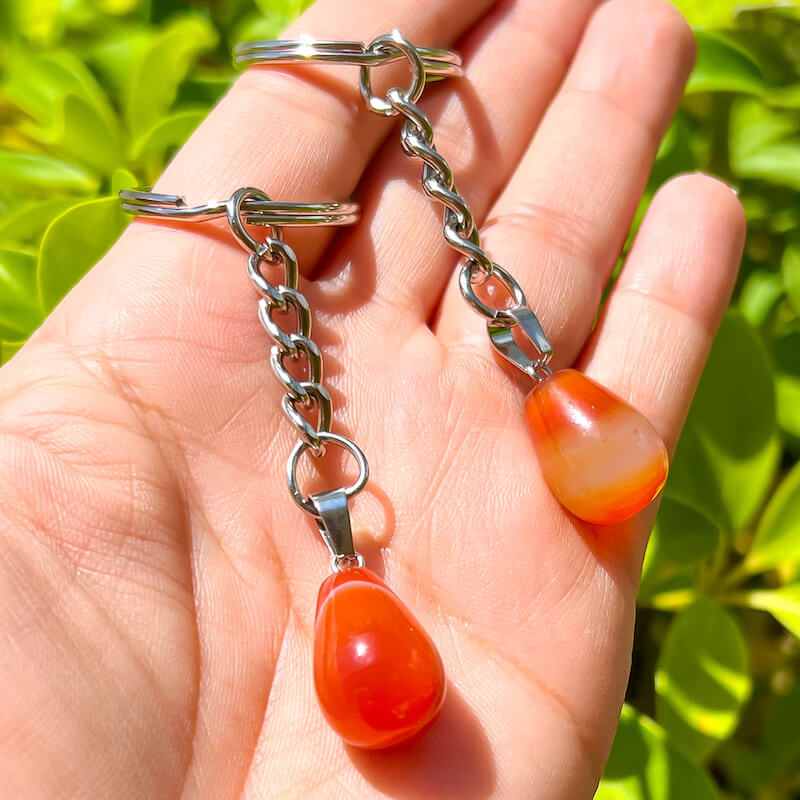 Tumbled Stone Carnelian Keychain. Carnelian keychain. Shop at Magic Crystals for Crystal Keychain, Pet Collar Charm, Bag Accessory, natural stone, crystal on the go, keychain charm, gift for her and him. Carnelian is a great for courage. Carnelian Natural Stone Keychain, Crystal Keychain, Carnelian Crystal Key Holder. Yellow gemstone.