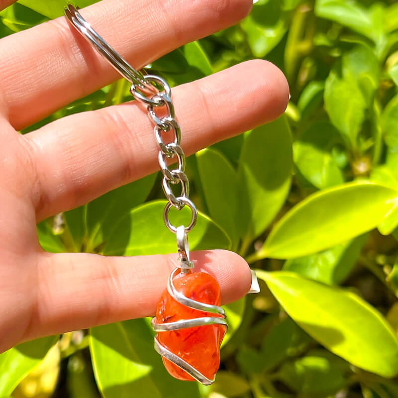 Tumbled Stone wrapped Carnelian Keychain. Carnelian keychain. Shop at Magic Crystals for Crystal Keychain, Pet Collar Charm, Bag Accessory, natural stone, crystal on the go, keychain charm, gift for her and him. Carnelian is a great for courage. Carnelian Natural Stone Keychain, Crystal Keychain, Carnelian Crystal Key Holder. Yellow gemstone.
