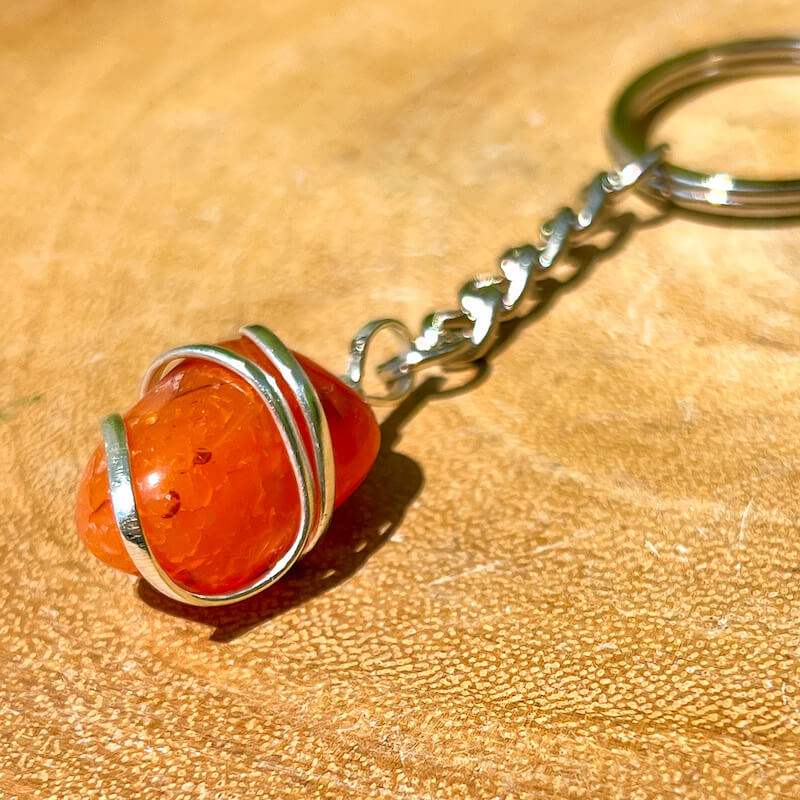 Tumbled Stone wrapped Carnelian Keychain. Carnelian keychain. Shop at Magic Crystals for Crystal Keychain, Pet Collar Charm, Bag Accessory, natural stone, crystal on the go, keychain charm, gift for her and him. Carnelian is a great for courage. Carnelian Natural Stone Keychain, Crystal Keychain, Carnelian Crystal Key Holder. Yellow gemstone.