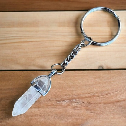 Clear Crystal Quartz keychain. Shop at Magic Crystals for Crystal Keychain, Pet Collar Charm, Bag Accessory, natural stone, crystal on the go, keychain charm, gift for her and him. Clear Crystal Quartz is a great for all hear. Clear Crystal Quartz Natural Stone Keychain, Crystal Keychain, Clear Crystal Quartz Crystal Key Holder. White clear gemstone.