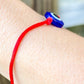 Shop at Magic Crystals for Protection. The Red String Bracelet has been worn throughout history in many cultures as a symbol of protection, faith, and good luck and acts as a shield from negativity and actually has many positive effects. In quite a few cultures a red string bracelet is believed to have magical powers. Evil-Eye-Red-String-protection-bracelet