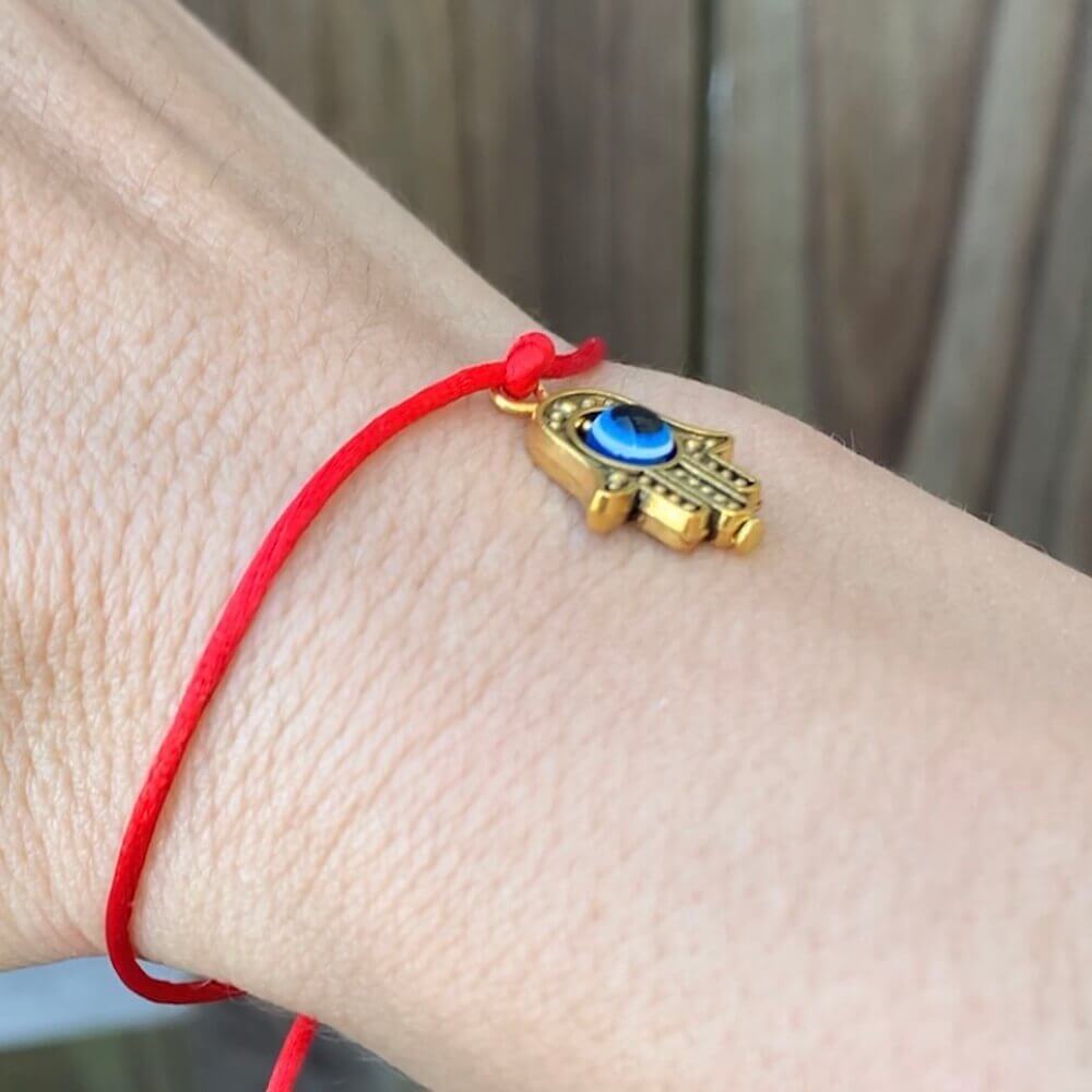 Golden-Hamsa-Protection-Bracelet.Shop at Magic Crystals for Protection. The Red String Bracelet has been worn throughout history in many cultures as a symbol of protection, faith, and good luck and acts as a shield from negativity and actually has many positive effects. In quite a few cultures a red string bracelet is believed to have magical powers.