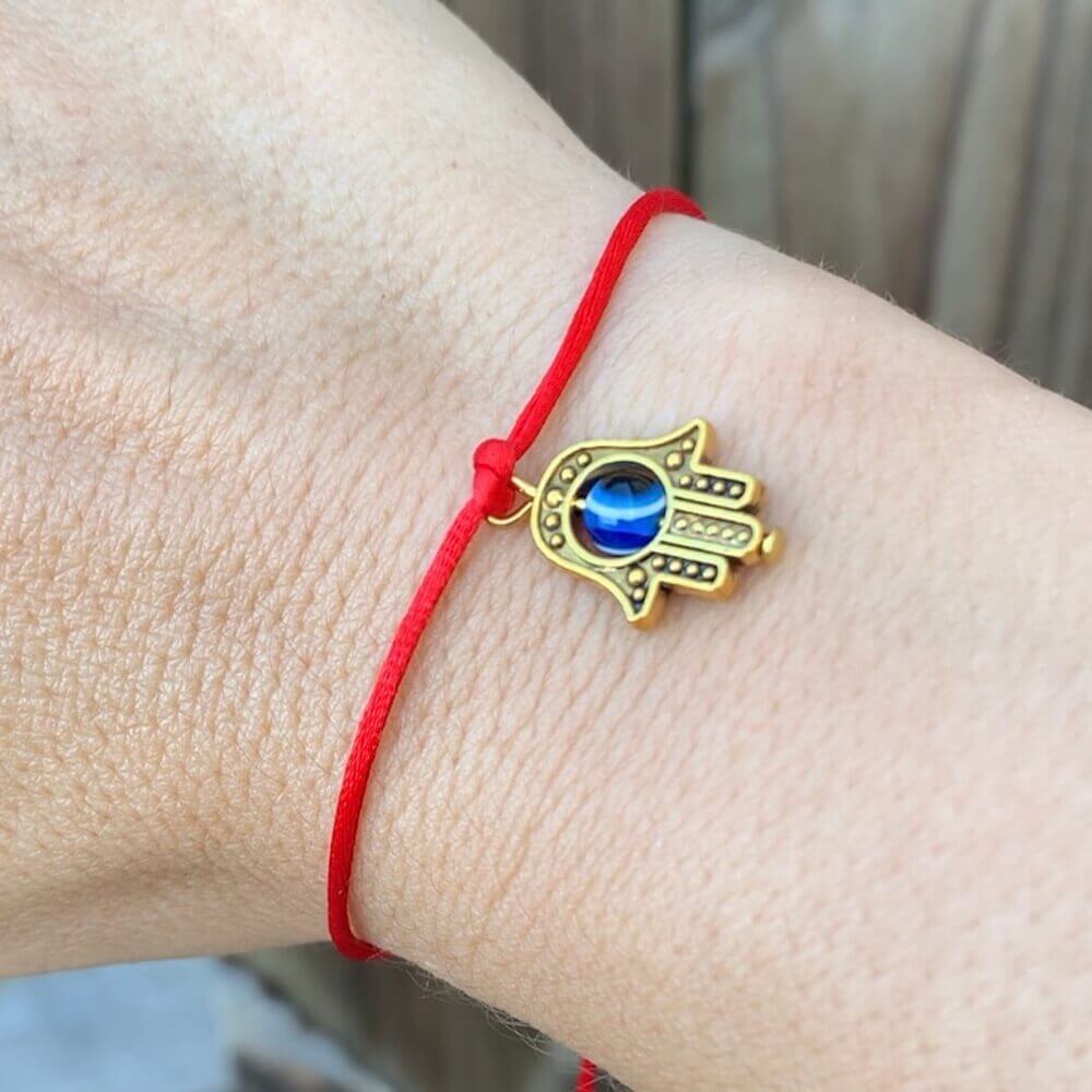 Golden-Hamsa-Protection-Bracelet.Shop at Magic Crystals for Protection. The Red String Bracelet has been worn throughout history in many cultures as a symbol of protection, faith, and good luck and acts as a shield from negativity and actually has many positive effects. In quite a few cultures a red string bracelet is believed to have magical powers.