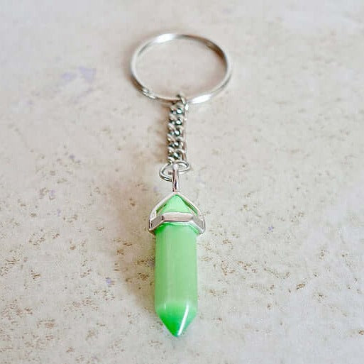 Cat's Eye keychain. Shop at Magic Crystals for Crystal Keychain, Pet Collar Charm, Bag Accessory, natural stone, crystal on the go, keychain charm, gift for her and him. Cat's Eye Natural Stone Keychain, Crystal Keychain, Cat's Eye Crystal Key Holder. pink, yellow, white, blue, and green gemstone.