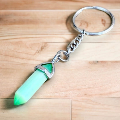 Cat's Eye keychain. Shop at Magic Crystals for Crystal Keychain, Pet Collar Charm, Bag Accessory, natural stone, crystal on the go, keychain charm, gift for her and him. Cat's Eye Natural Stone Keychain, Crystal Keychain, Cat's Eye Crystal Key Holder. pink, yellow, white, blue, and green gemstone.